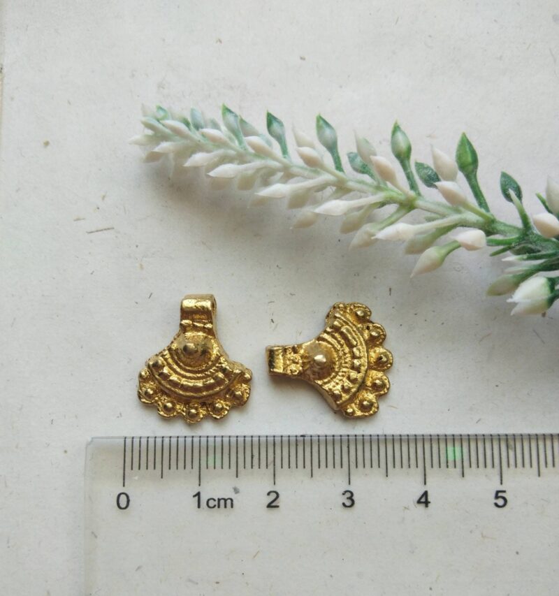 Brass Charms – Elegant display of brass charms in a boho style, ideal for creative accents.