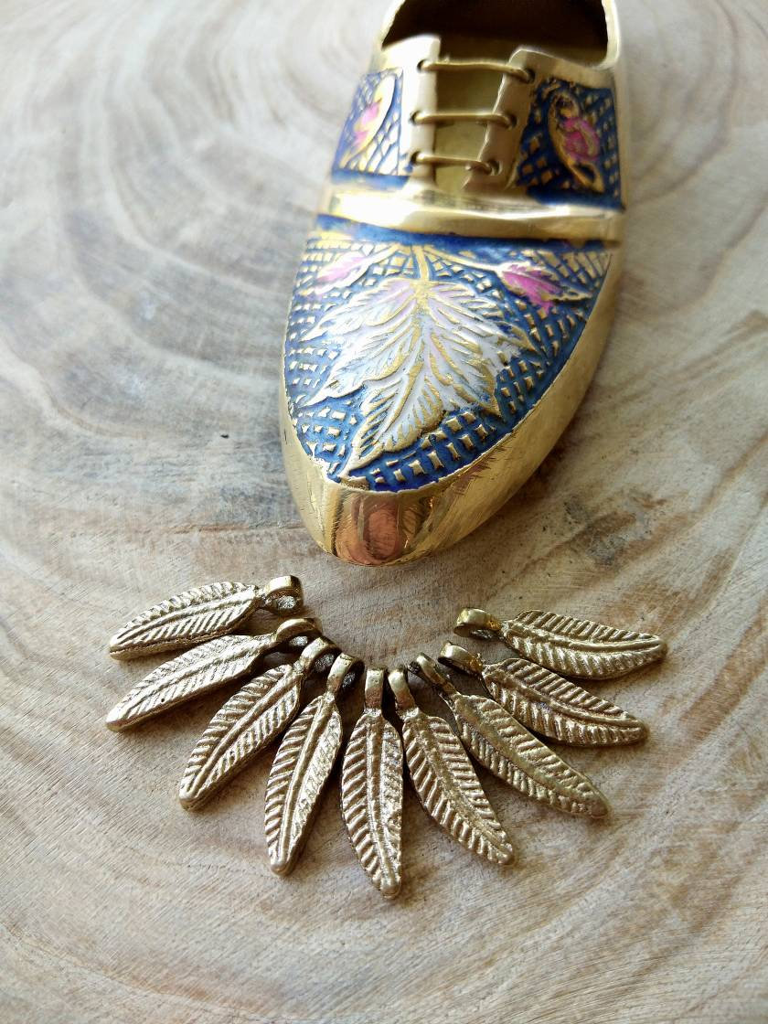Mini feather charms – Handcrafted brass feather details.